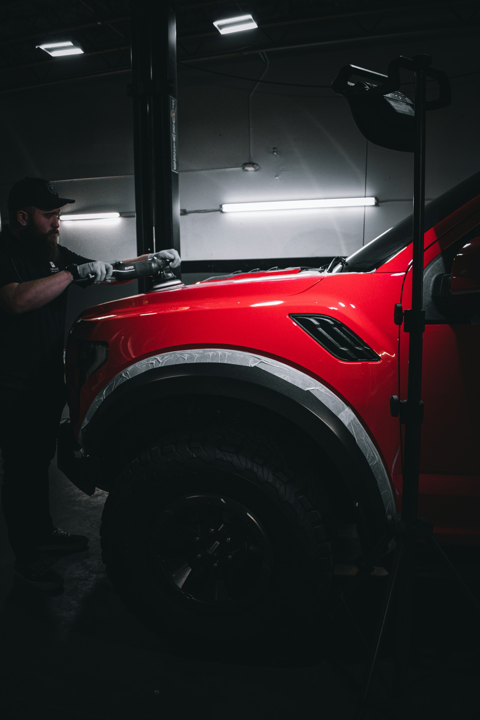 Detailer machine-polishing a vehicle’s paint