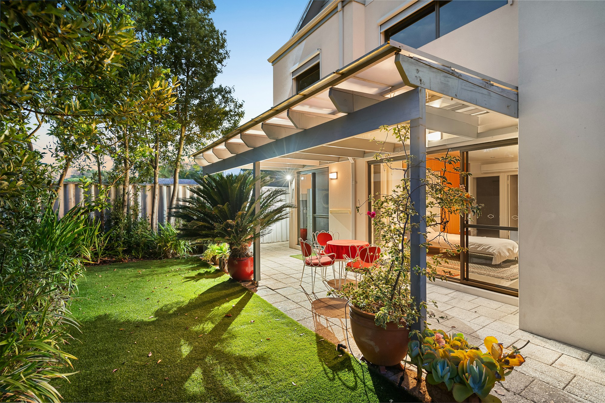 Covered residential patio opening onto a garden